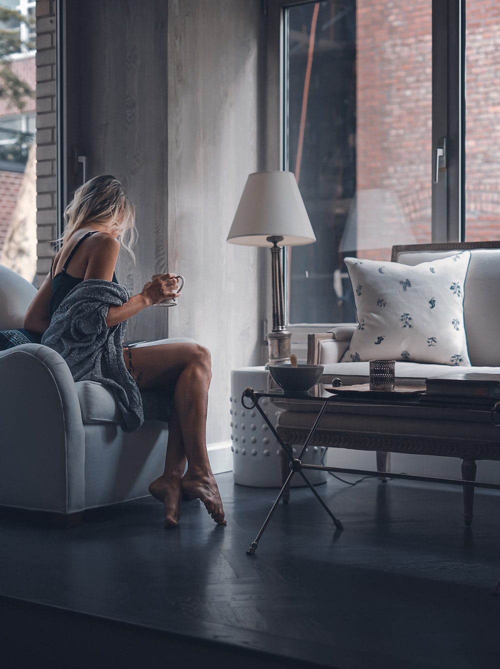 The 50 Shades of Grey: A Guide to Grey Flooring 3 Girl sitting with a coffee on a grey floor