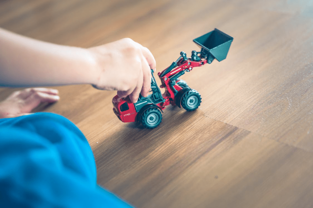 5 Reasons To Install Wood Flooring In Your Home 3 Kid playing on wood floor with a tractor