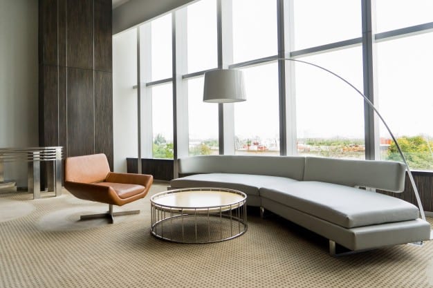 3 Ways To Protect Your Commercial Flooring During The Summer 3 A modern meeting room beside a huge window with office furniture and carpeted flooring.