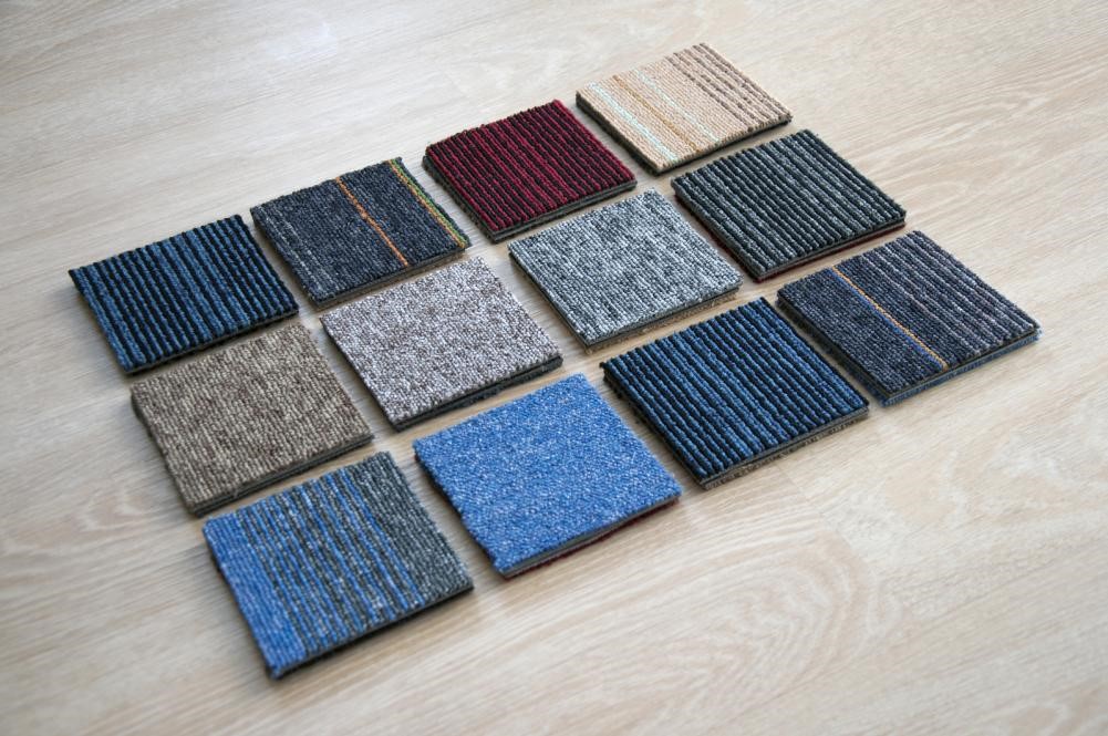Carpet Tiles vs Wall-to-Wall Carpets – Which Is Better? 2 Multiple carpet samples on the floor.